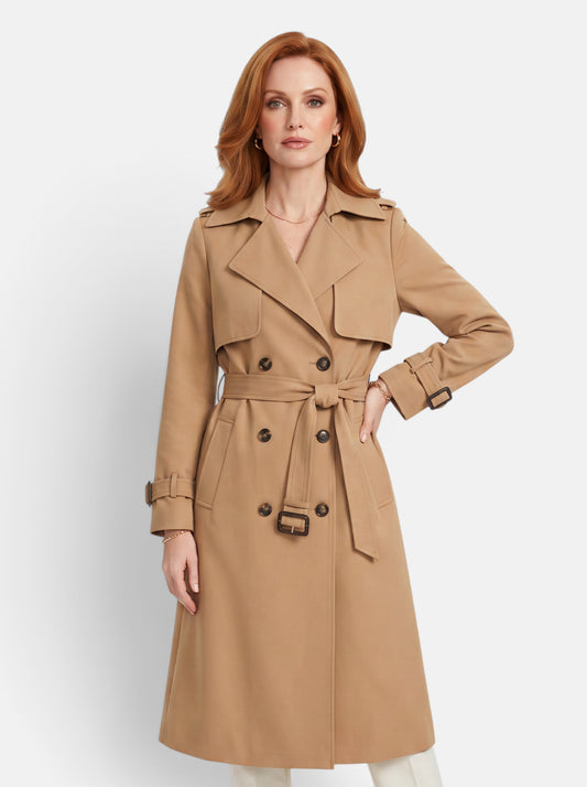 A woman wearing a Venatte beige double-breasted long trench coat with a belted waist and turn-down collar.