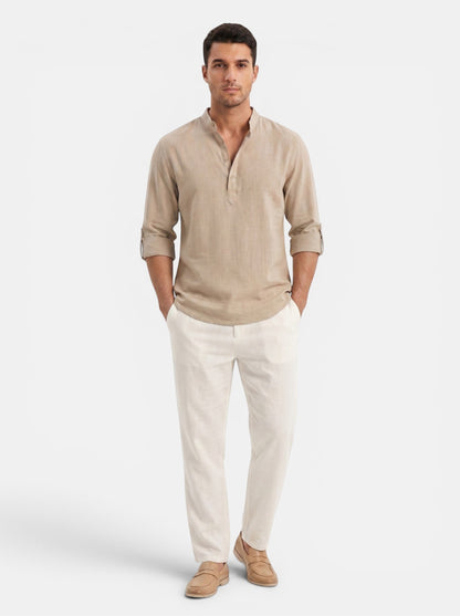 Men's tan cotton-linen long-sleeve Henley shirt with buttoned placket and rolled cuffs.