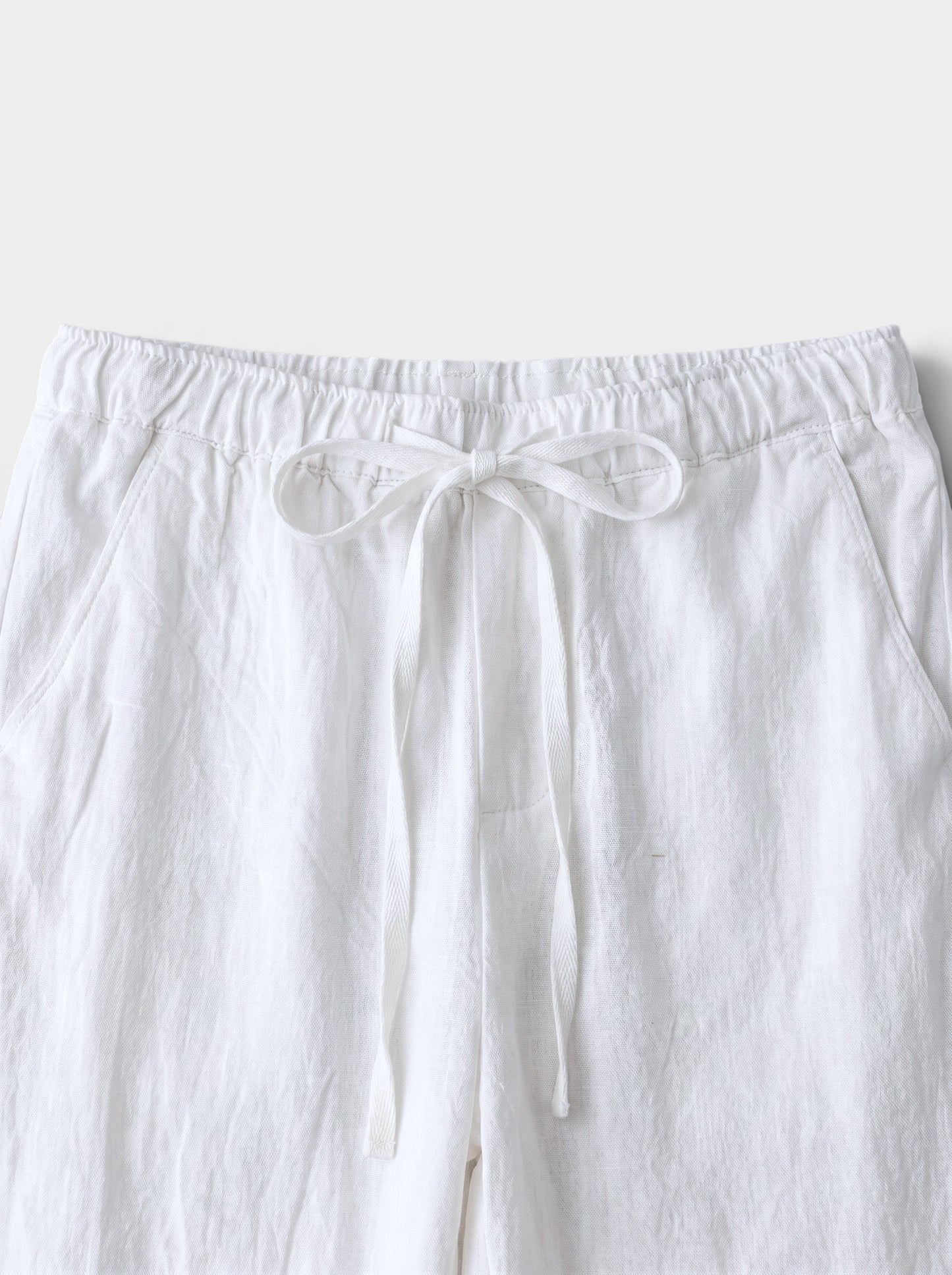 Men's white cotton linen relaxed fit wide-leg casual pants with drawstring waist and back pocket.