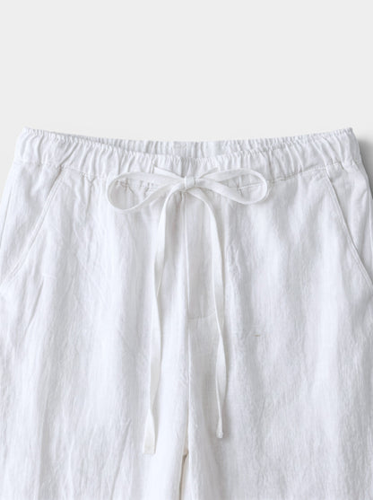 Men's white cotton linen relaxed fit wide-leg casual pants with drawstring waist and back pocket.