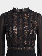 Venatte black crochet lace mesh jumpsuit with sheer sleeves and mock neck. Perfect for evening events.