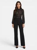 Venatte black crochet lace mesh jumpsuit with long sheer sleeves and flared legs. Elegant evening wear.