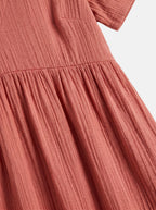 Venatte women's coral pink ruffled mini dress with V-neck and A-line silhouette, made of soft polyester blend.