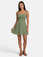 Venatte green floral print mini sundress with spaghetti straps and tie details, made of polyester blend.