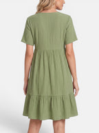 Venatte olive green ruffled mini dress with V-neck and A-line silhouette, made of soft polyester blend.