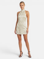 Venatte cream and black polka dot halter mini dress with a backless design and lace-up back.