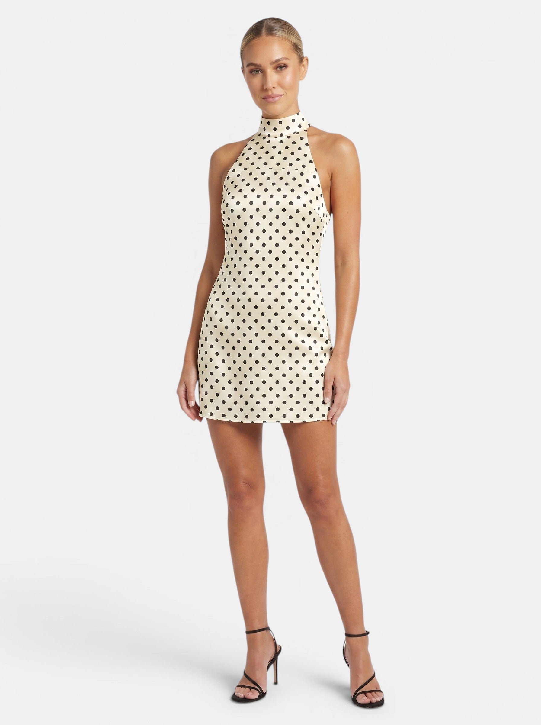 Venatte cream and black polka dot halter mini dress with a backless design and lace-up back.