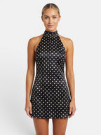 Venatte black and cream polka dot halter mini dress with backless lace-up detail and sleeveless cut.