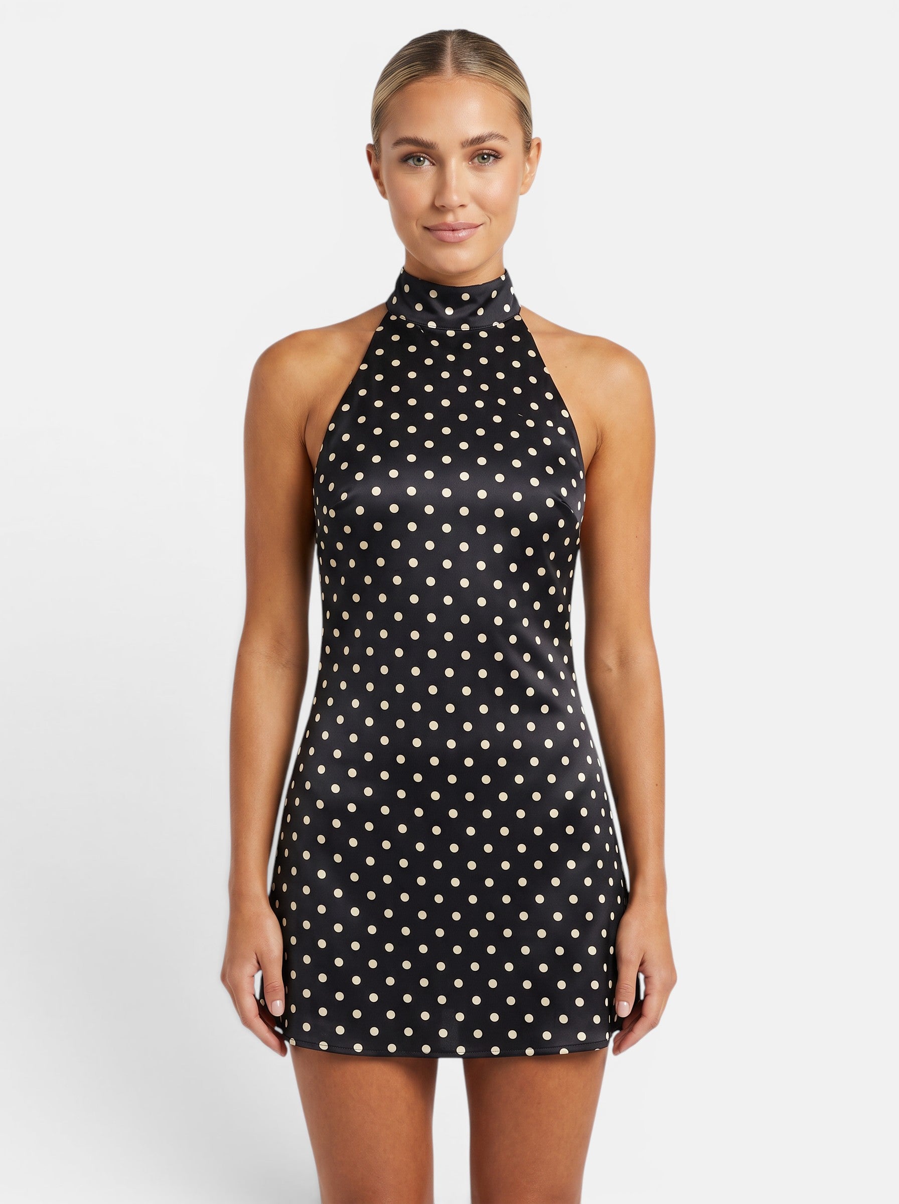 Venatte black and cream polka dot halter mini dress with backless lace-up detail and sleeveless cut.