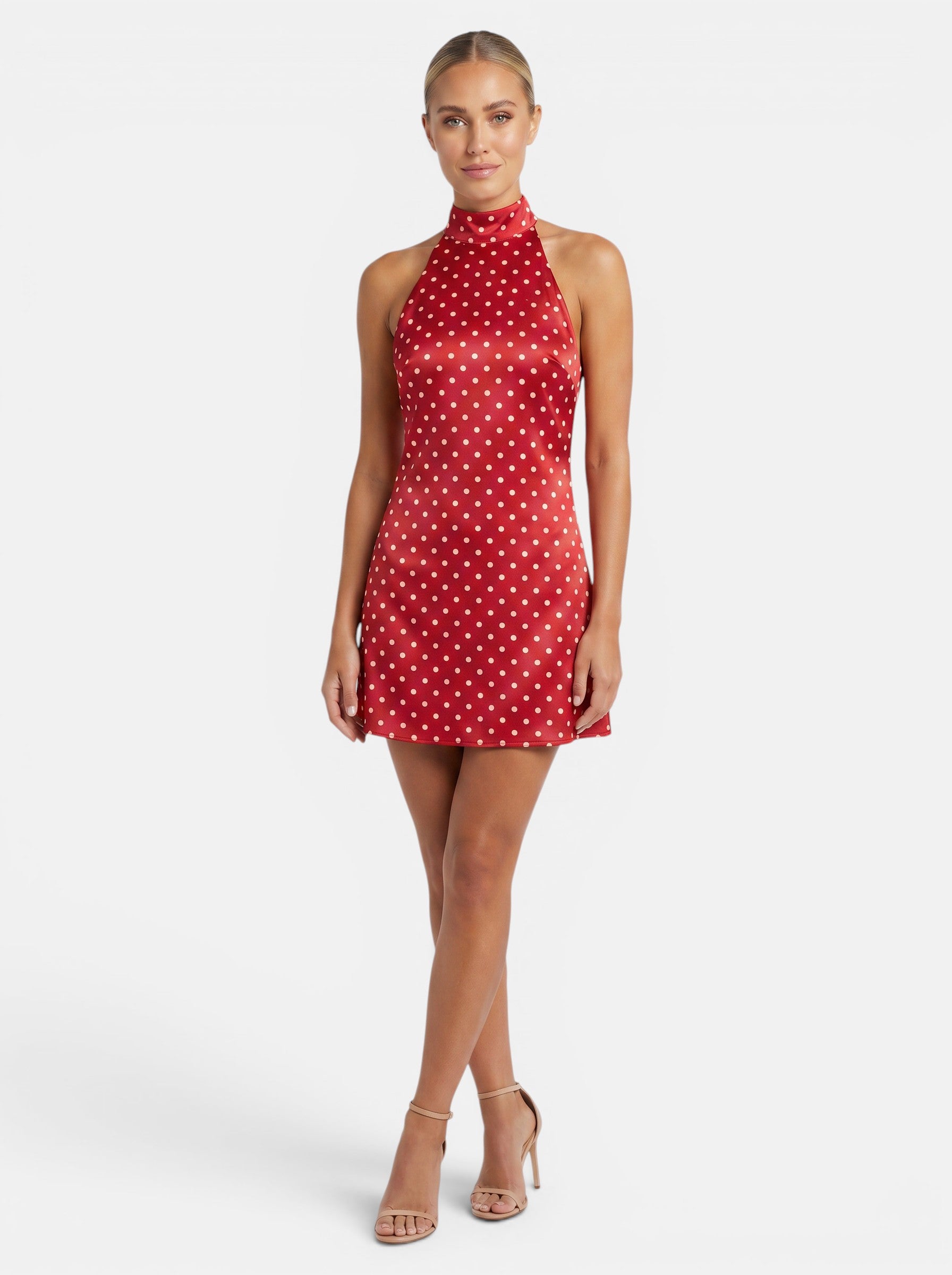 Venatte red polka dot halter mini dress with backless silhouette and lace-up back. Polyester and elastane blend.