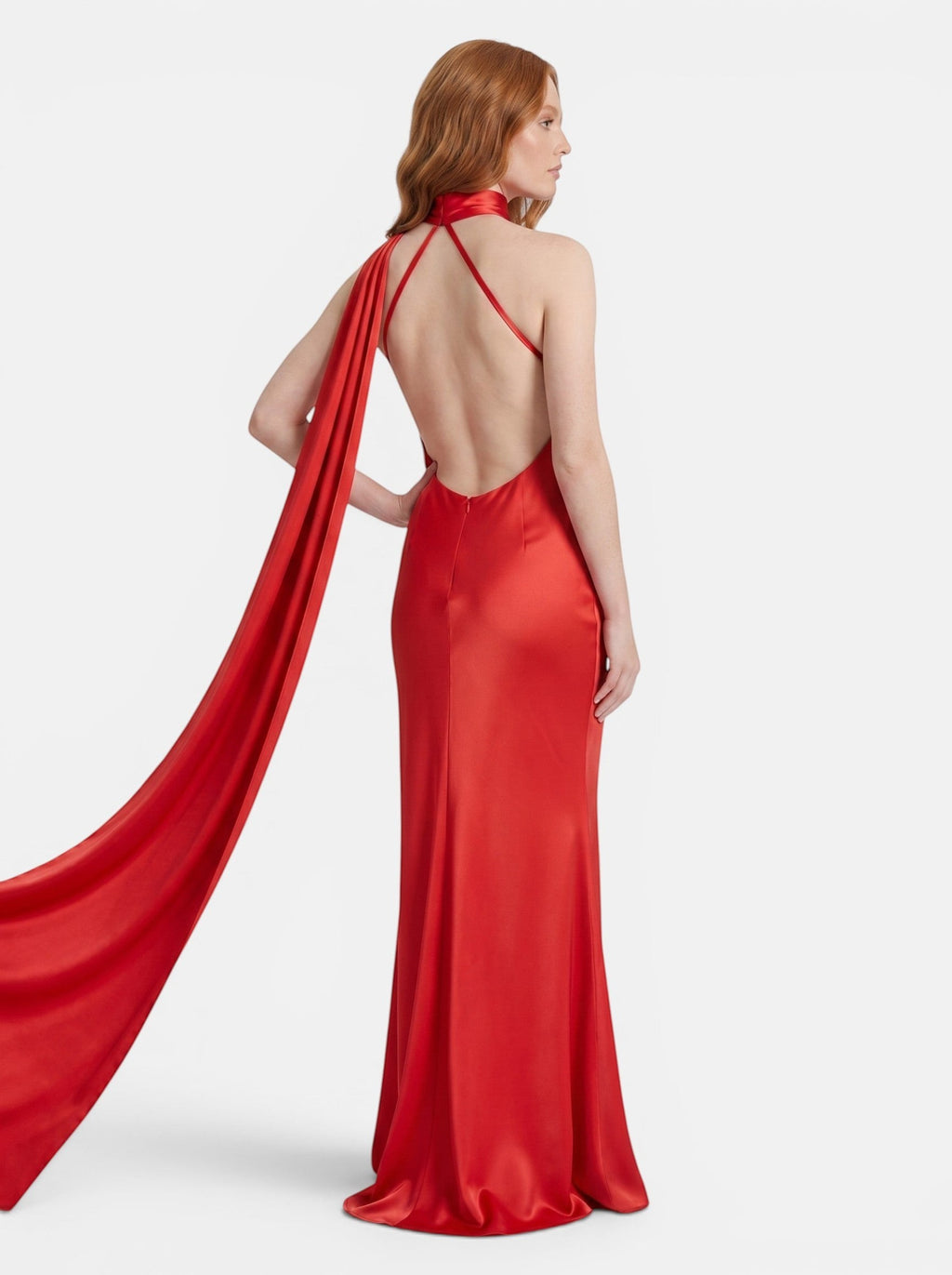 Venatte red satin style halter party dress with flowing back detail and open back. Elegant evening wear.