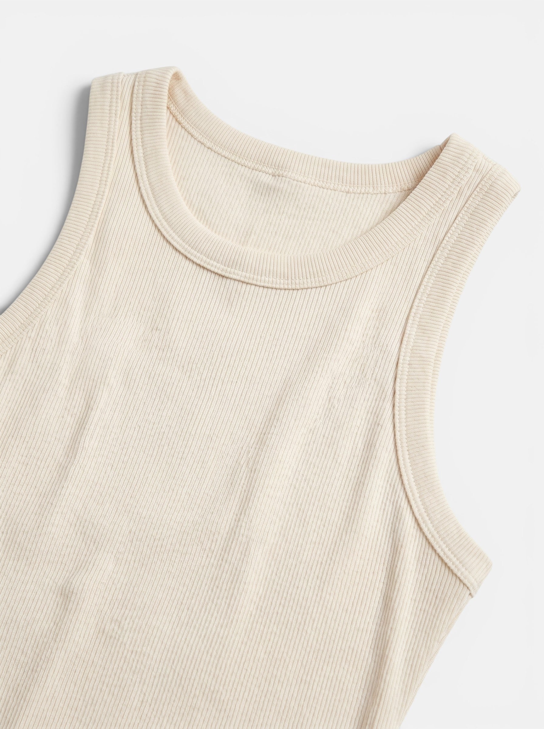 Venatte cream ribbed bodycon mini dress, sleeveless, made from a soft polyester blend with stretch.