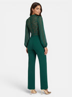 Venatte women's emerald green jumpsuit with long sheer sleeves, lace mesh back, and wide legs. Elegant evening wear.