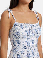 Venatte women's white mini sundress with blue floral print and tie spaghetti straps. Lightweight polyester blend.