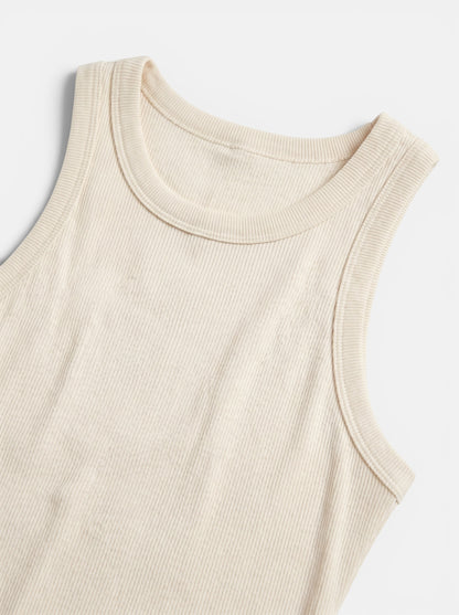 Women's cream ribbed bodycon mini dress, sleeveless, made from a soft polyester blend with stretch.